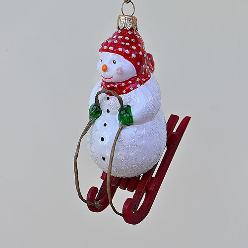Schneemann auf einem Schlitten Mundgeblasener Weihnachtsschmuck Kunsthandel Rueckeshaeuser